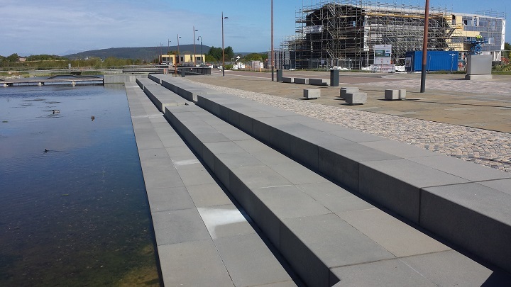 A cluster of stone seats supplied by CED offer views looking out over the pond…